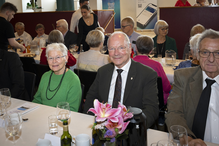 Judi Dench et al. sitting at a table