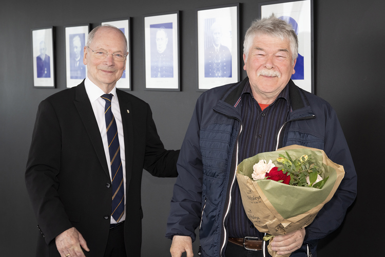 a man holding a bouquet of flowers next to a man holding a bouquet of flowers
