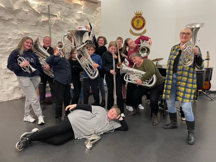 a group of people posing for a photo with instruments